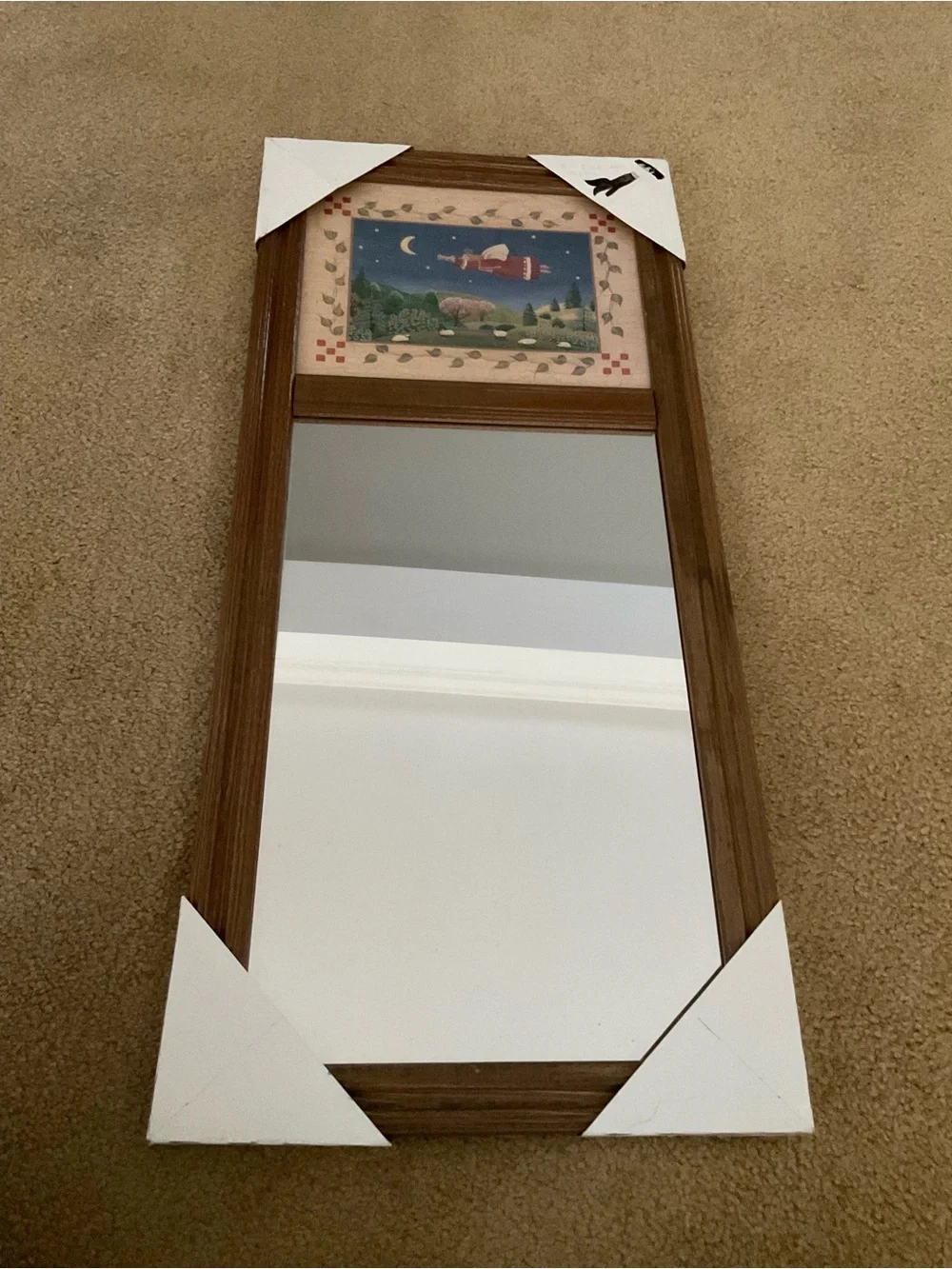 Vintage wood-framed trumeau mirror with a folk art print